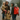Family of four, including two children and a woman with a red PrepMates backpack, walking through a flooded street during a rainstorm.